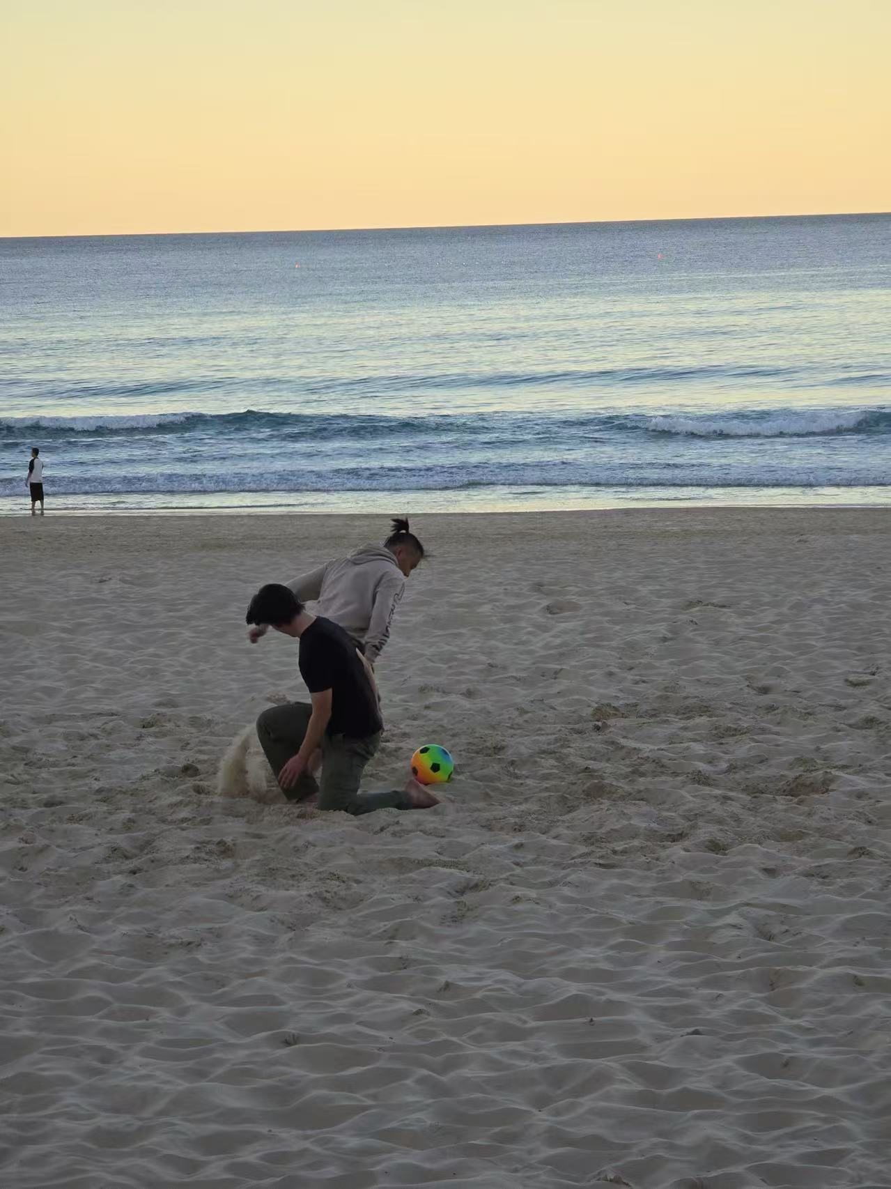 Playing on a beach at sunset