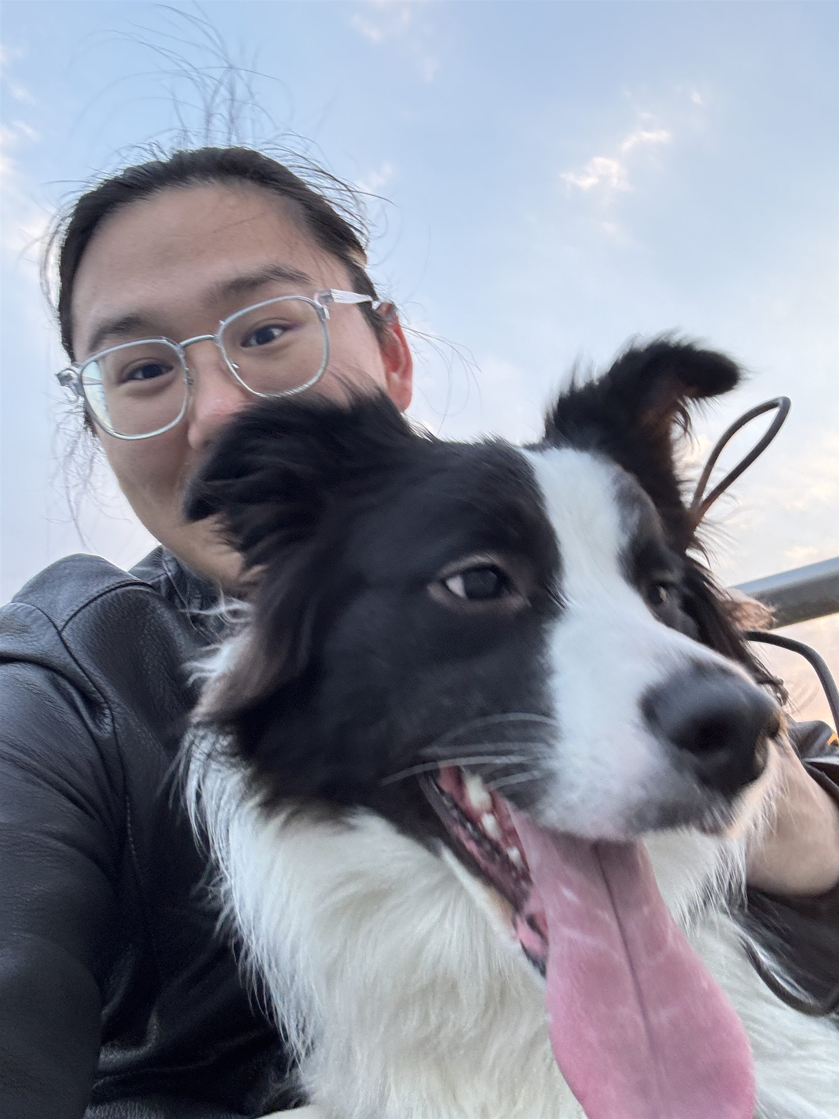 Jesse Liu taking a selfie with a dog