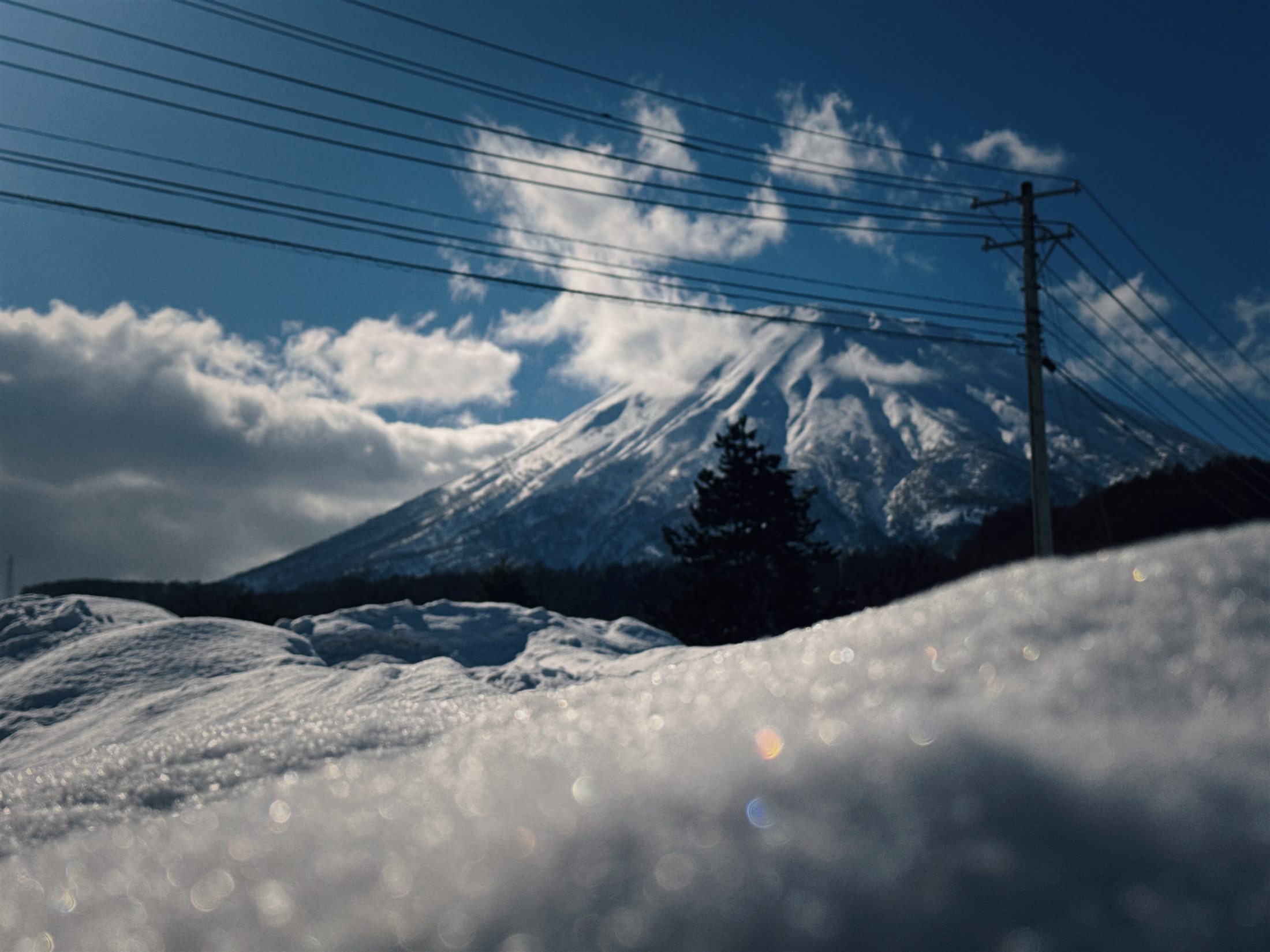 Mount Fuji beyond snow and power lines