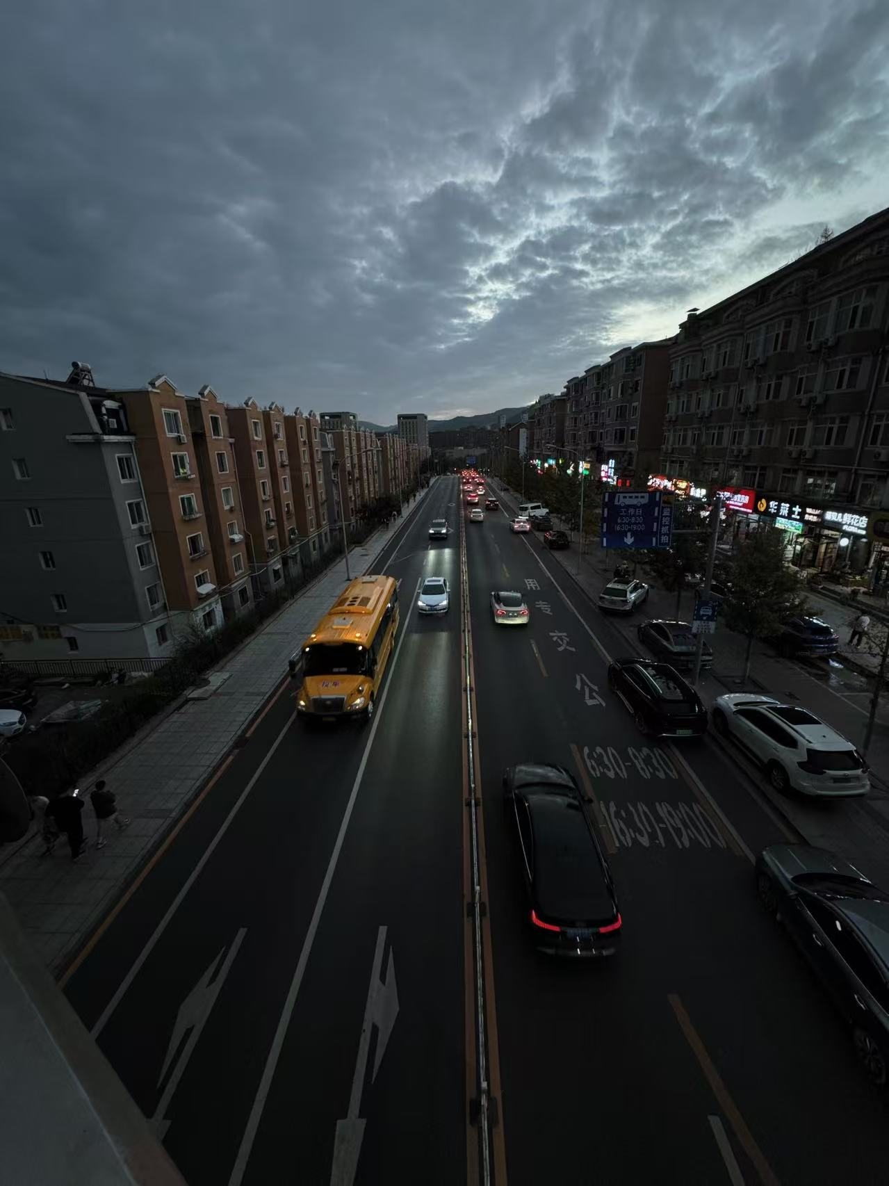 City traffic beneath a dramatic evening sky